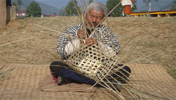 Men making bamboo basket in Bhutan